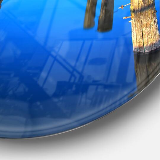 Designart 'Wooden Pier Remains In Blue Sea Modern Wall Clock